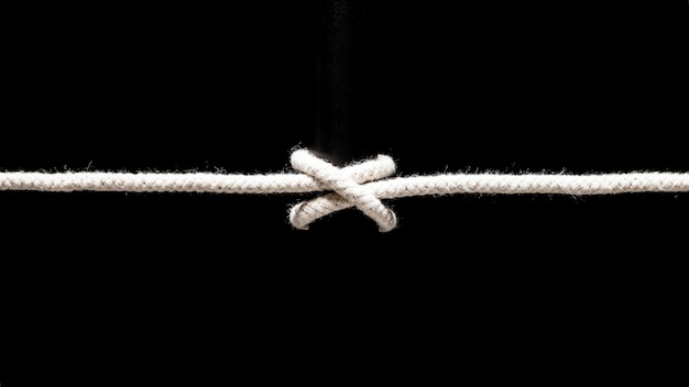 Twisted cotton rope on black background