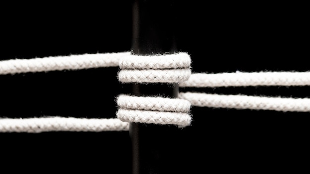 Free photo twisted cotton rope and black bar