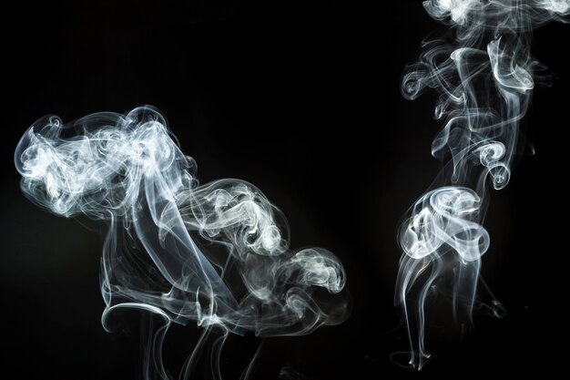 Two abstract white smoke silhouettes