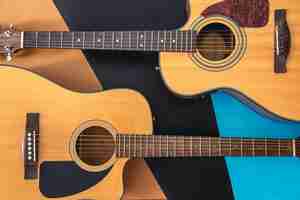 Free photo two acoustic guitars on a colored background flat lay