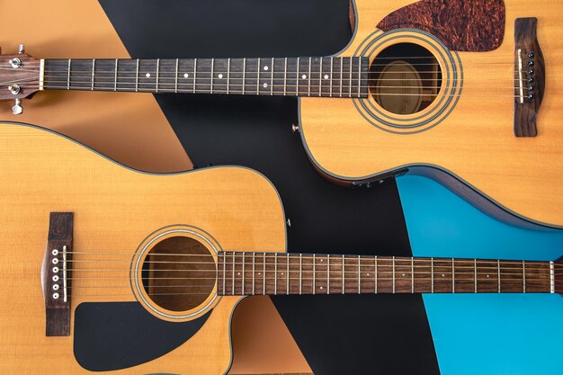 Two acoustic guitars on a colored background flat lay