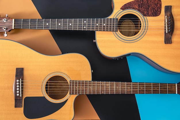 Two acoustic guitars on a colored background flat lay