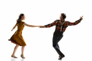 Free photo two active dancers, man and woman, training boogie woogie dance isolated over white wall