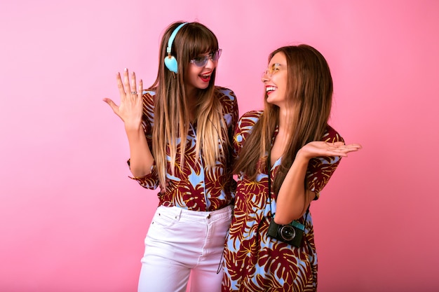 Two adorable happy young women having fun together