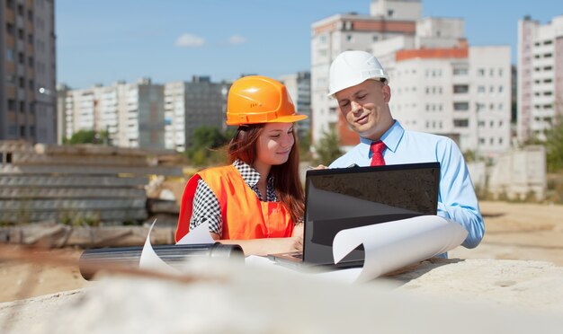 Two architects  in front of building site