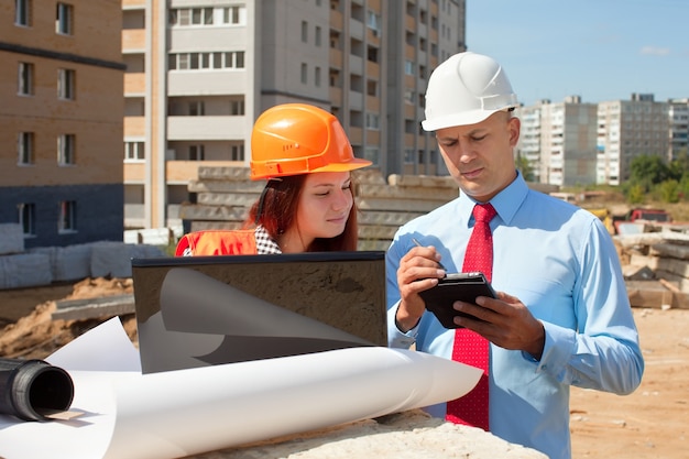 Free photo two architects in front of building site