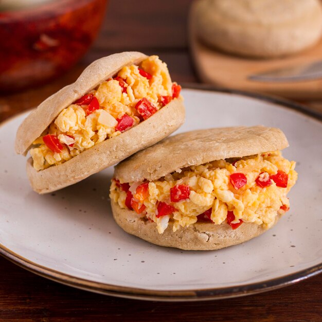 Two arepas with filling on plate