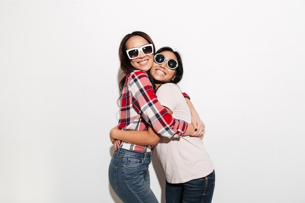 Two asian pretty cheerful ladies sisters