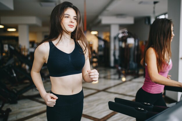 Two athletic girls in the gym