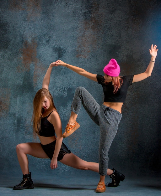 two attractive girls dancing twerk in