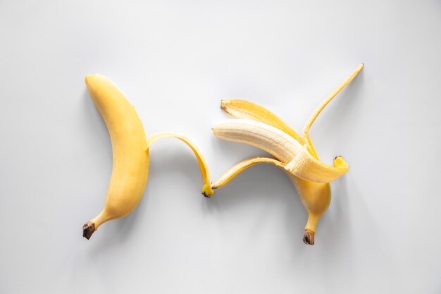 Two bananas on a white background isolated conceptual minimalism