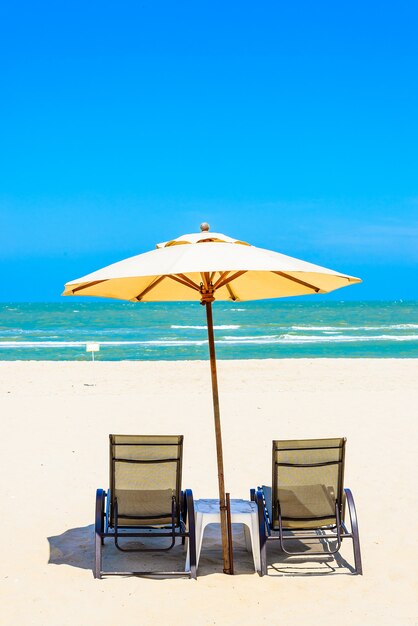 Two beach chairs on white sand