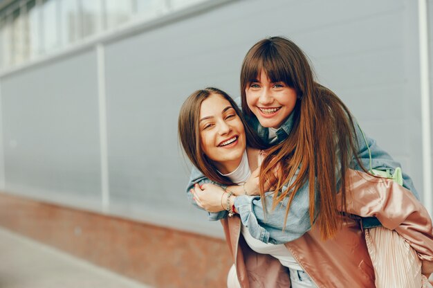 Two beautiful girls are walking around the city