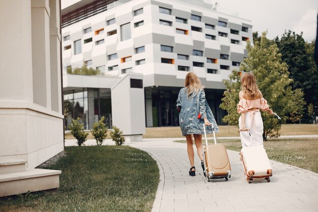 Two beautiful girls standing by the airport