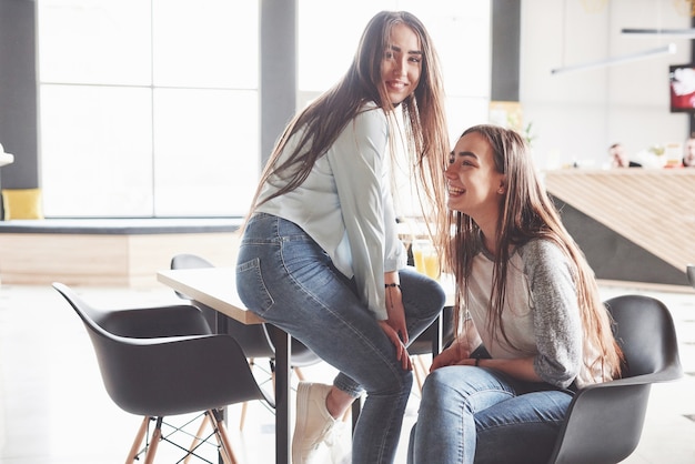 Free photo two beautiful twin girls spend time.