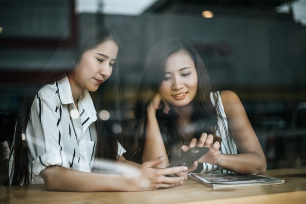 Two beautiful women talking everything together at coffee shop cafe