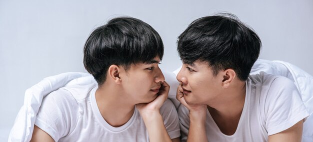 Two beloved young men slept in bed together.