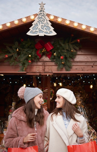 Free photo two best female friends on christmas market