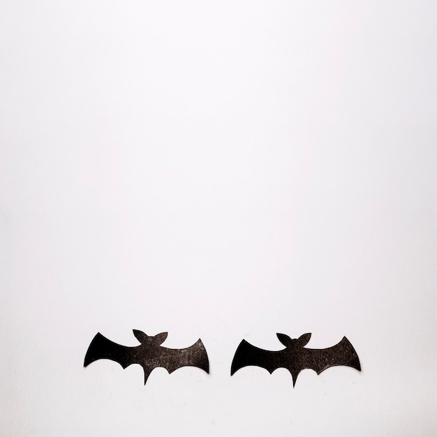 Two black bats on white