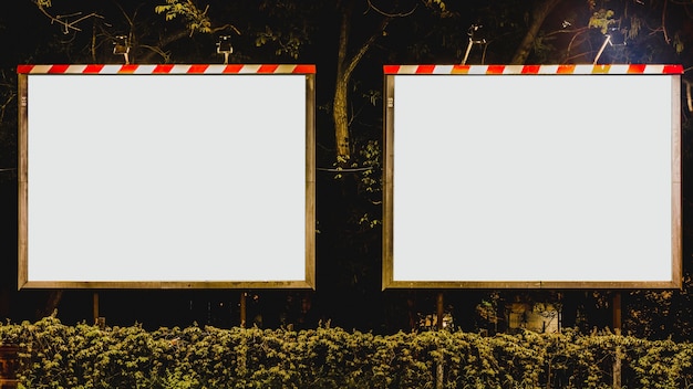 Two blank white advertising billboard in the park