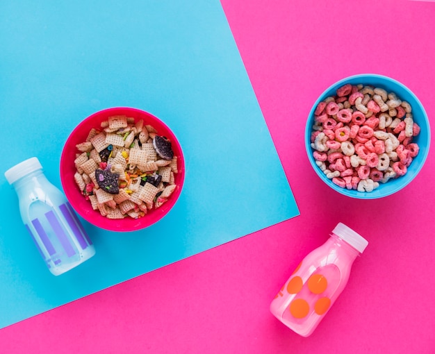 Two bowls of cereals with milk on table