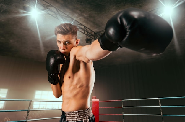 Free photo two boxers are fighting on professional boxing ring