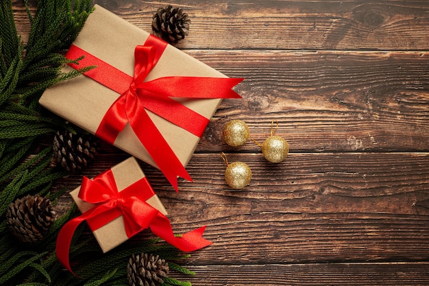 Two boxes of present with red ribbon bow on wooden background