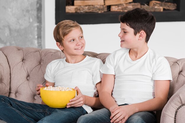 Two boys talking and sitting on couch