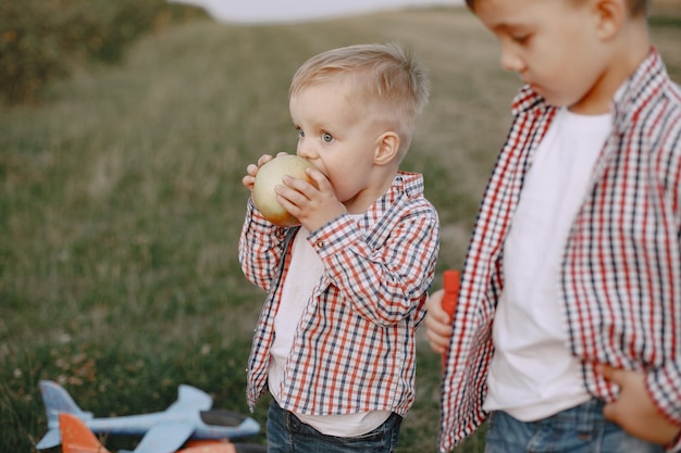 Two brothers playing in a summer field