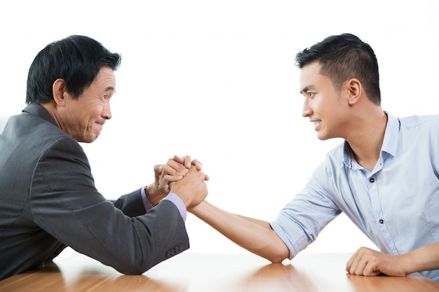 Free photo two business men arm wrestling aggressively