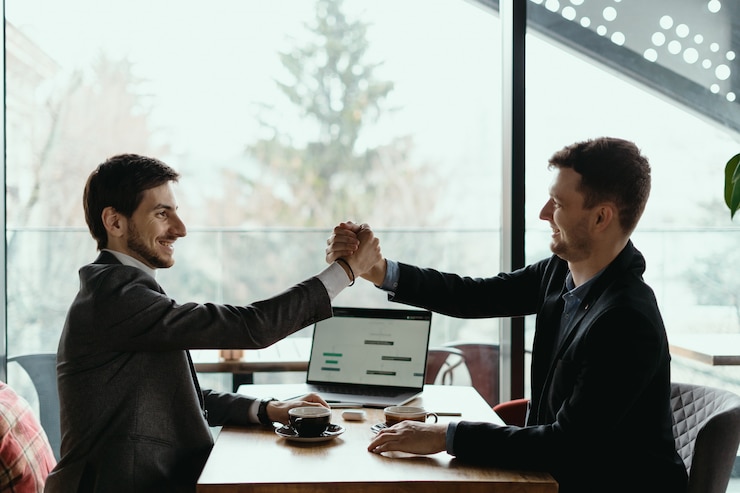Free Photo two business men celebrating a deal