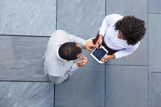 Two business partners looking at tablet