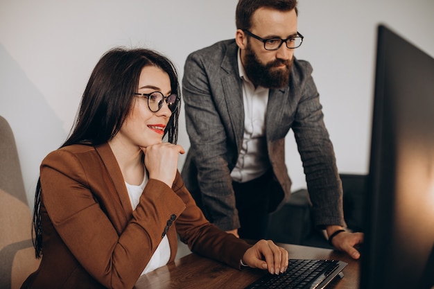 Two business partners working together in office on computer