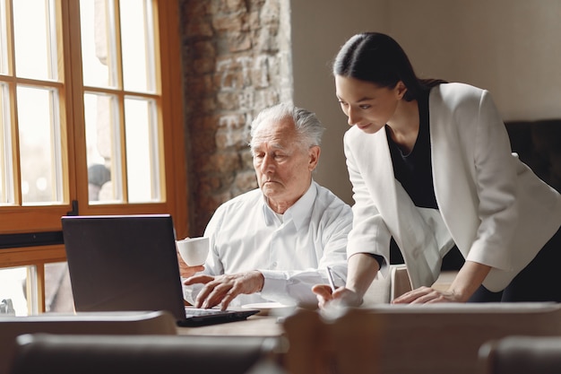 Two business partners working with a laptop in a cafe