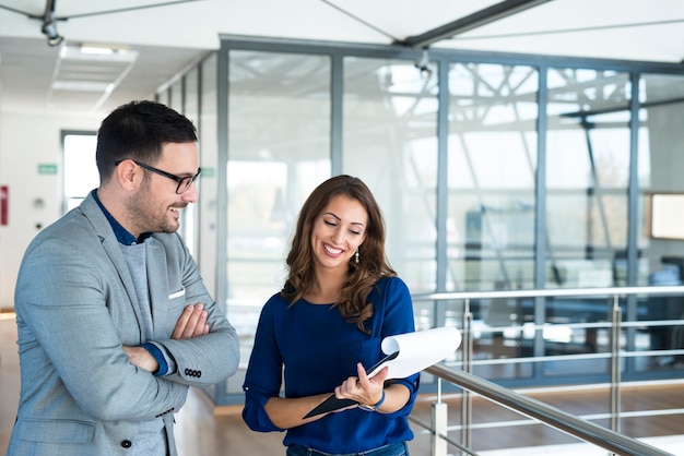 Two business people analyzing project together