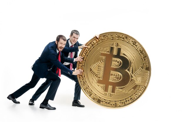 Two businessmen holding bitcoin