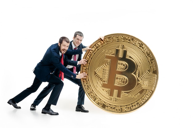 Two businessmen holding bitcoin