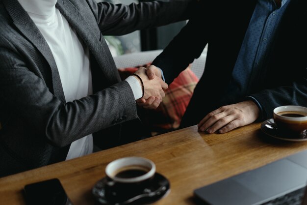 Two businessmen shaking hands as sign of agreement