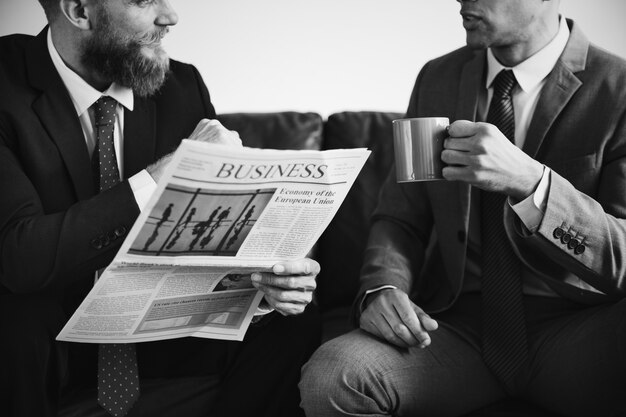 Two businessmen sitting on a couch