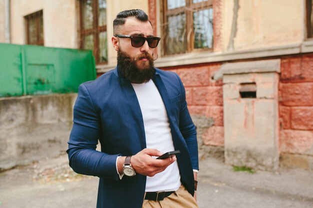 Two businessmen talking on the phone in the city