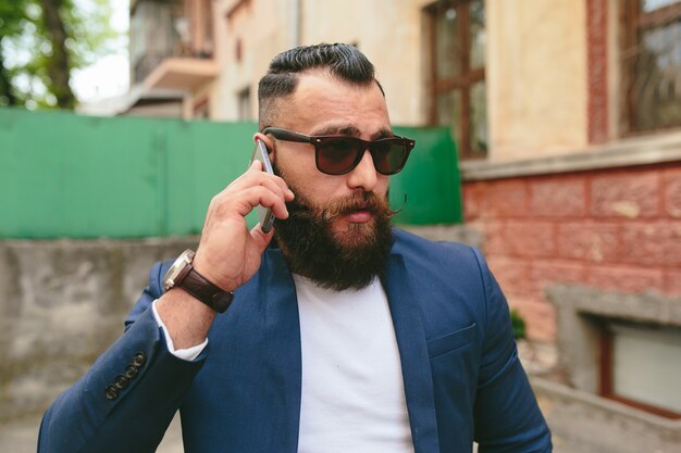 Two businessmen talking on the phone in the city