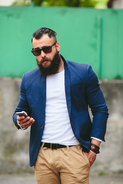 Two businessmen talking on the phone in the city