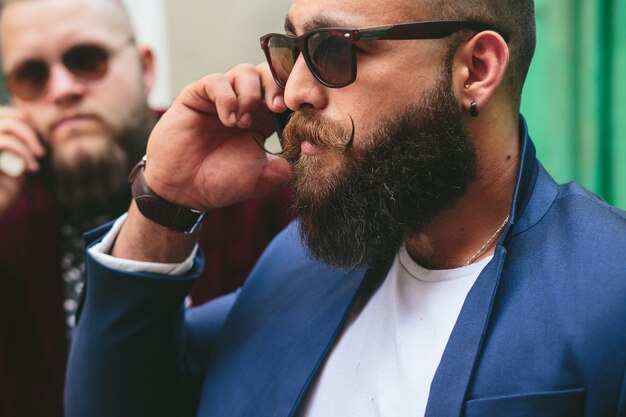 Two businessmen talking on the phone in the city