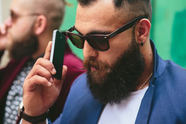 Two businessmen talking on the phone in the city