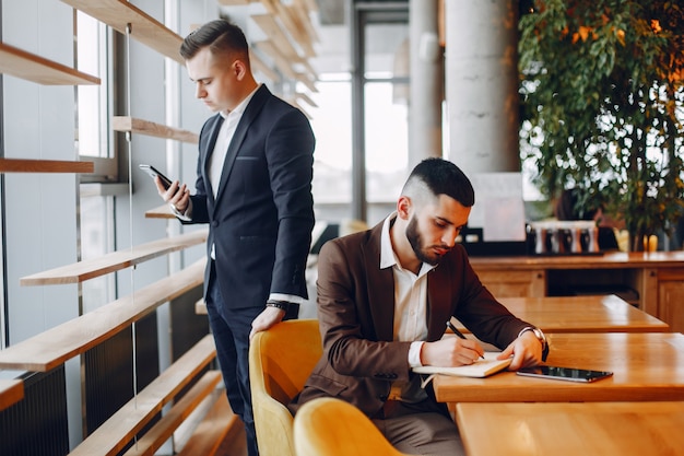 Two businessmen working in a cafe