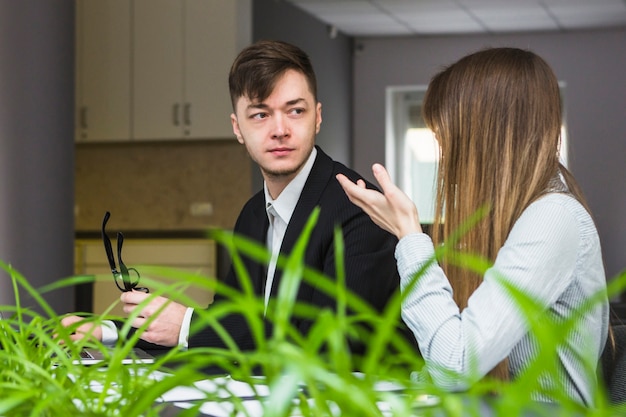 Free photo two businesspeople having conversation in office