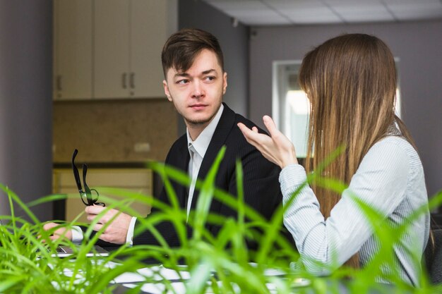 Two businesspeople having conversation in office