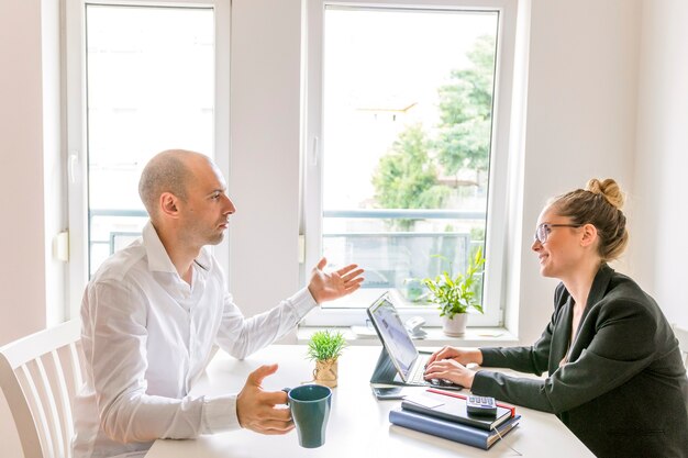 Two businesspeople having conversation in office