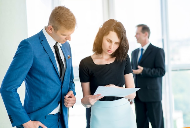 Two businesspeople looking at documents in office