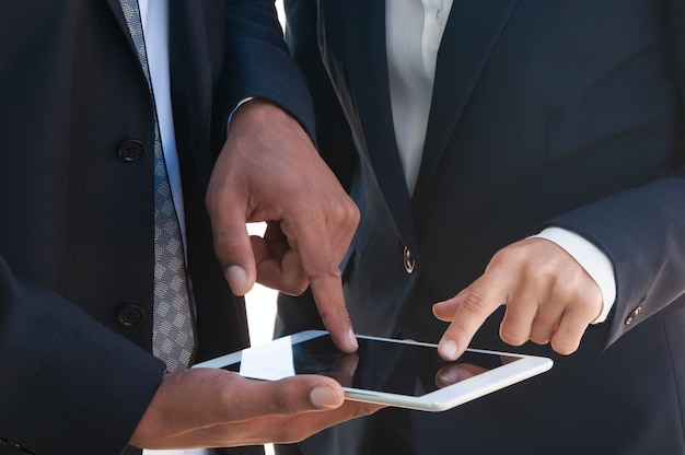 Two businesspeople using tablet together